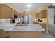 Bright kitchen with stainless steel appliances, wood cabinets, and ample counter space at 35046 Smoketree Ln, Dade City, FL 33523