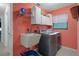 Well-lit laundry room featuring modern machines and ample storage at 35046 Smoketree Ln, Dade City, FL 33523