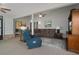 Spacious living area featuring comfortable seating, bright lighting, and connection to other rooms at 35046 Smoketree Ln, Dade City, FL 33523