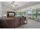 Spacious living room filled with natural light and featuring comfortable seating and a ceiling fan at 35046 Smoketree Ln, Dade City, FL 33523