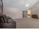 Spacious living room featuring a ceiling fan, carpet, sliding glass door, and red accent wall at 35046 Smoketree Ln, Dade City, FL 33523