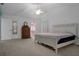 This is a main bedroom with vaulted ceilings, a ceiling fan, dresser, and a view into the main bathroom at 35046 Smoketree Ln, Dade City, FL 33523