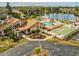 Capture the beauty of amenities including the pool, shuffleboard court, clubhouse, and pond from above at 3832 Sailmaker Ln # 3832, Holiday, FL 34691