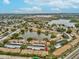 A stunning aerial view capturing the property's proximity to a serene lake and surrounding community at 3832 Sailmaker Ln # 3832, Holiday, FL 34691