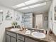 Bathroom featuring double sinks, vanity with granite countertops, and an expansive mirror at 3832 Sailmaker Ln # 3832, Holiday, FL 34691