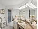 Bright bathroom featuring a granite vanity with large mirrors and a walk-in shower at 3832 Sailmaker Ln # 3832, Holiday, FL 34691