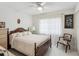 Cozy bedroom featuring a wooden bed frame, soft lighting, ceiling fan, and sheer curtains at 3832 Sailmaker Ln # 3832, Holiday, FL 34691