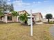 Inviting villa with lovely landscaping including palm trees and a well-maintained lawn at 3832 Sailmaker Ln # 3832, Holiday, FL 34691