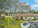 Landscaped front yard featuring a large tree, green grass, and a well kept lawn at 3832 Sailmaker Ln # 3832, Holiday, FL 34691