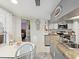 Open kitchen with granite countertops, white cabinets, and adjacent breakfast nook at 3832 Sailmaker Ln # 3832, Holiday, FL 34691