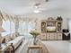 Bright living room featuring vaulted ceilings, fan, elegant furniture, and large windows at 3832 Sailmaker Ln # 3832, Holiday, FL 34691
