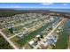 Scenic aerial view of waterfront homes with boat docks and canals extending to the ocean under a sunny blue sky at 4048 Bluefish Dr, Hernando Beach, FL 34607