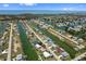 Scenic aerial view of waterfront homes with boat docks and canals extending to the ocean under a sunny blue sky at 4048 Bluefish Dr, Hernando Beach, FL 34607