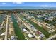 Scenic aerial view of waterfront homes with boat docks and canals extending to the ocean under a sunny blue sky at 4048 Bluefish Dr, Hernando Beach, FL 34607