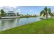 Scenic canal view from the lush green backyard featuring a pristine waterfront lifestyle at 4048 Bluefish Dr, Hernando Beach, FL 34607