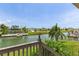 Backyard water view overlooking lush greenery and waterfront homes in a canal community at 4048 Bluefish Dr, Hernando Beach, FL 34607