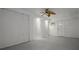 Basement with a ceiling fan, exterior door, paneled walls, and concrete floors at 4048 Bluefish Dr, Hernando Beach, FL 34607