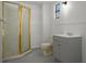 Bathroom featuring a glass shower stall, cream-colored toilet, grey vanity, and panelled lower walls at 4048 Bluefish Dr, Hernando Beach, FL 34607