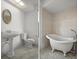 Bathroom featuring a pedestal sink, a toilet, wainscoting, and decorative mirror at 4048 Bluefish Dr, Hernando Beach, FL 34607