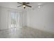 Bright bedroom features updated ceiling fan, track lighting, and sliding glass doors at 4048 Bluefish Dr, Hernando Beach, FL 34607