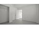 Bedroom view of white walls, grey floor, and closet, through open doors at 4048 Bluefish Dr, Hernando Beach, FL 34607