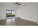 Bright bedroom with hardwood floors and sliding doors that lead to the lanai at 4048 Bluefish Dr, Hernando Beach, FL 34607