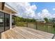 Exterior view of a wooden deck overlooking a scenic waterfront and trees at 4048 Bluefish Dr, Hernando Beach, FL 34607