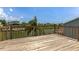 Wooden deck with railing overlooking a picturesque waterfront view of a canal community at 4048 Bluefish Dr, Hernando Beach, FL 34607