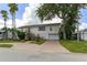 Charming home featuring mature trees, landscaping, and a welcoming front entrance at 4048 Bluefish Dr, Hernando Beach, FL 34607