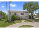 Inviting home with a well-manicured lawn, front garden, and a welcoming stairway entrance at 4048 Bluefish Dr, Hernando Beach, FL 34607