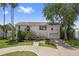 Charming two-story home with landscaped yard and a circular driveway on a sunny day at 4048 Bluefish Dr, Hernando Beach, FL 34607