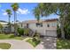 Inviting two-story home featuring well-maintained landscaping and a charming stairway entrance at 4048 Bluefish Dr, Hernando Beach, FL 34607