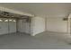 Garage area showing concrete floor, a door and the white siding and garage door at 4048 Bluefish Dr, Hernando Beach, FL 34607