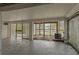 Garage area, partially enclosed, featuring concrete floor and walls, and some greenery at 4048 Bluefish Dr, Hernando Beach, FL 34607