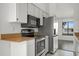 Kitchen with stainless steel appliances, white cabinets, and granite countertops at 4048 Bluefish Dr, Hernando Beach, FL 34607