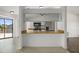 Features a breakfast bar, white cabinets, stainless steel appliances, and tiled flooring at 4048 Bluefish Dr, Hernando Beach, FL 34607