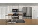 Kitchen with stainless steel appliances and white cabinets with matching countertops at 4048 Bluefish Dr, Hernando Beach, FL 34607