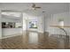 Open-concept living area with wood floors, an adjacent kitchen bar, and stairs to the upper level at 4048 Bluefish Dr, Hernando Beach, FL 34607