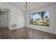 Bright living room with wood floors, large windows, and a decorative chandelier fixture at 4048 Bluefish Dr, Hernando Beach, FL 34607