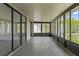Large screened porch with wood flooring and view of landscaping and waterfront at 4048 Bluefish Dr, Hernando Beach, FL 34607