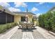 Spacious paved patio with an outdoor dining set and manicured green hedges at 4072 Everett Ave, Spring Hill, FL 34609