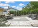 Spacious paved patio with outdoor dining set and seating area surrounded by manicured greenery at 4072 Everett Ave, Spring Hill, FL 34609