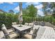 Large patio with an outdoor dining set, umbrella, and lounge chairs, perfect for entertaining at 4072 Everett Ave, Spring Hill, FL 34609