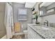 Bathroom featuring a granite countertop, chrome fixtures, and decorative shelves for extra storage at 4072 Everett Ave, Spring Hill, FL 34609