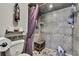 Modern tiled shower with a stone-look surround, a corner seat, and a decorative accent border at 4072 Everett Ave, Spring Hill, FL 34609