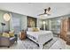 Bright main bedroom features a ceiling fan, ensuite bath, and natural light at 4072 Everett Ave, Spring Hill, FL 34609