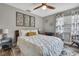 Serene bedroom featuring neutral tones, decorative wall art, and a comfortable-looking bed with accent pillows at 4072 Everett Ave, Spring Hill, FL 34609
