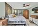Bedroom featuring a ceiling fan, ensuite bath, and natural light at 4072 Everett Ave, Spring Hill, FL 34609