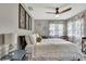 Serene bedroom featuring neutral tones, decorative wall art, and a comfortable-looking bed with accent pillows at 4072 Everett Ave, Spring Hill, FL 34609