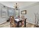 Cozy dining room featuring natural light, stylish chandelier, and wood flooring at 4072 Everett Ave, Spring Hill, FL 34609